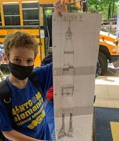 kid holding poster bus